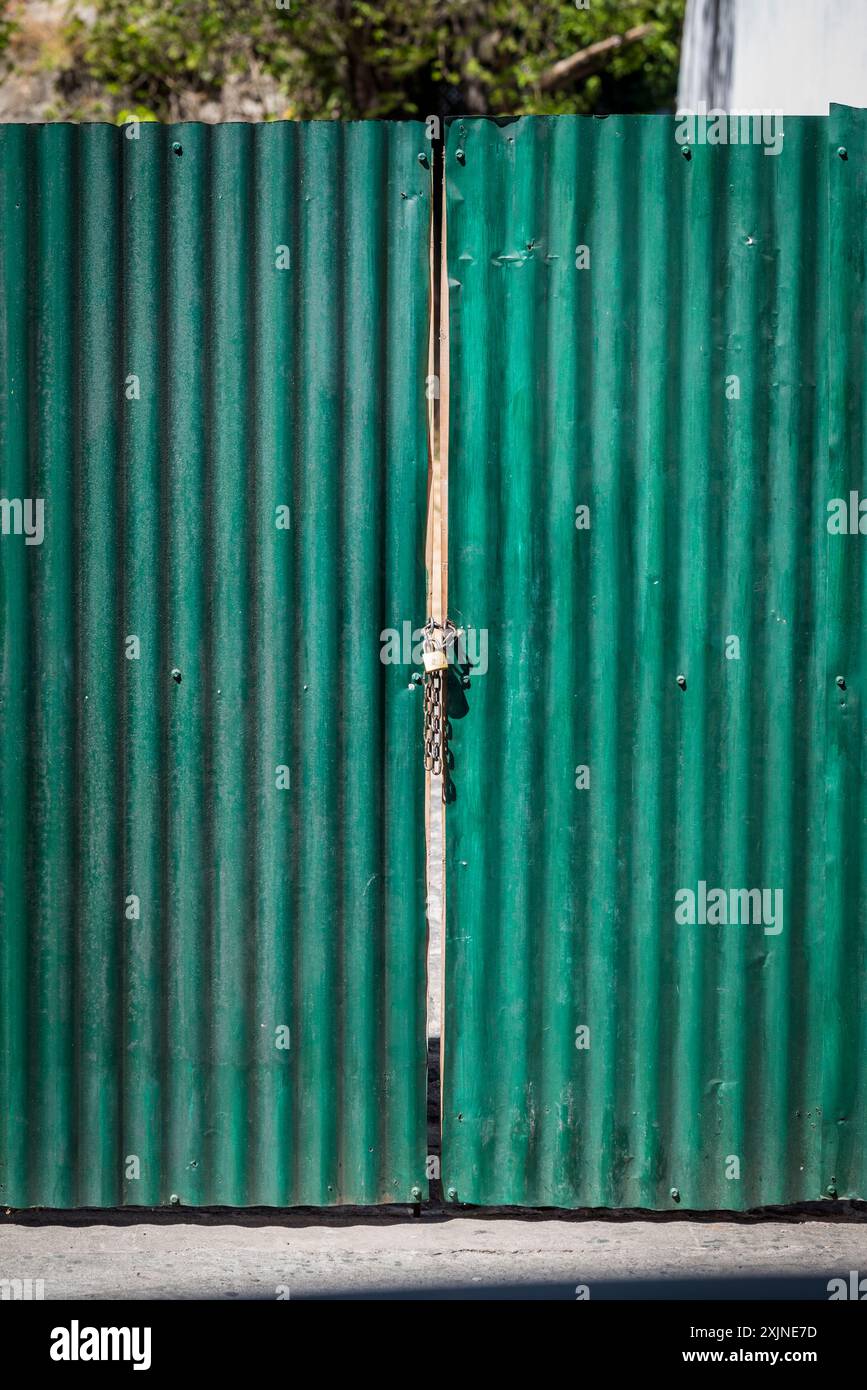 Green corrugated metal door, Antigua, Guatemala Stock Photo