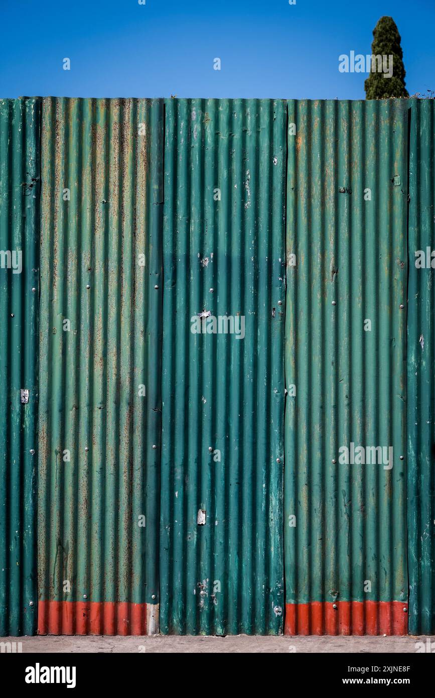 Green corrugated metal door, Antigua, Guatemala Stock Photo