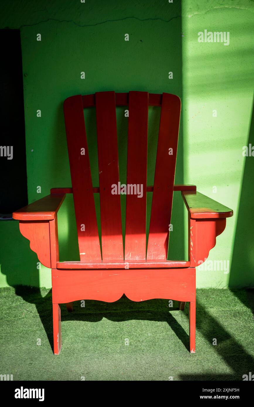 Red chair against green wall, San Pedro La Laguna, Guatemala Stock Photo