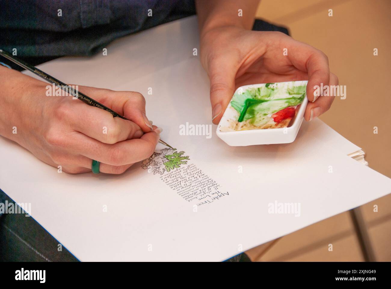 Artists hands with fine paint brush Stock Photo