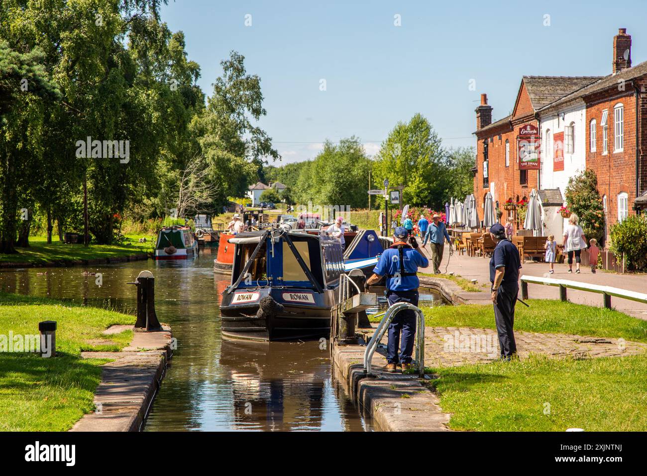 Canal narrowboat passing through the locks at Fradley Junction  Staffordshire on the Trent and Mersey canal Stock Photo