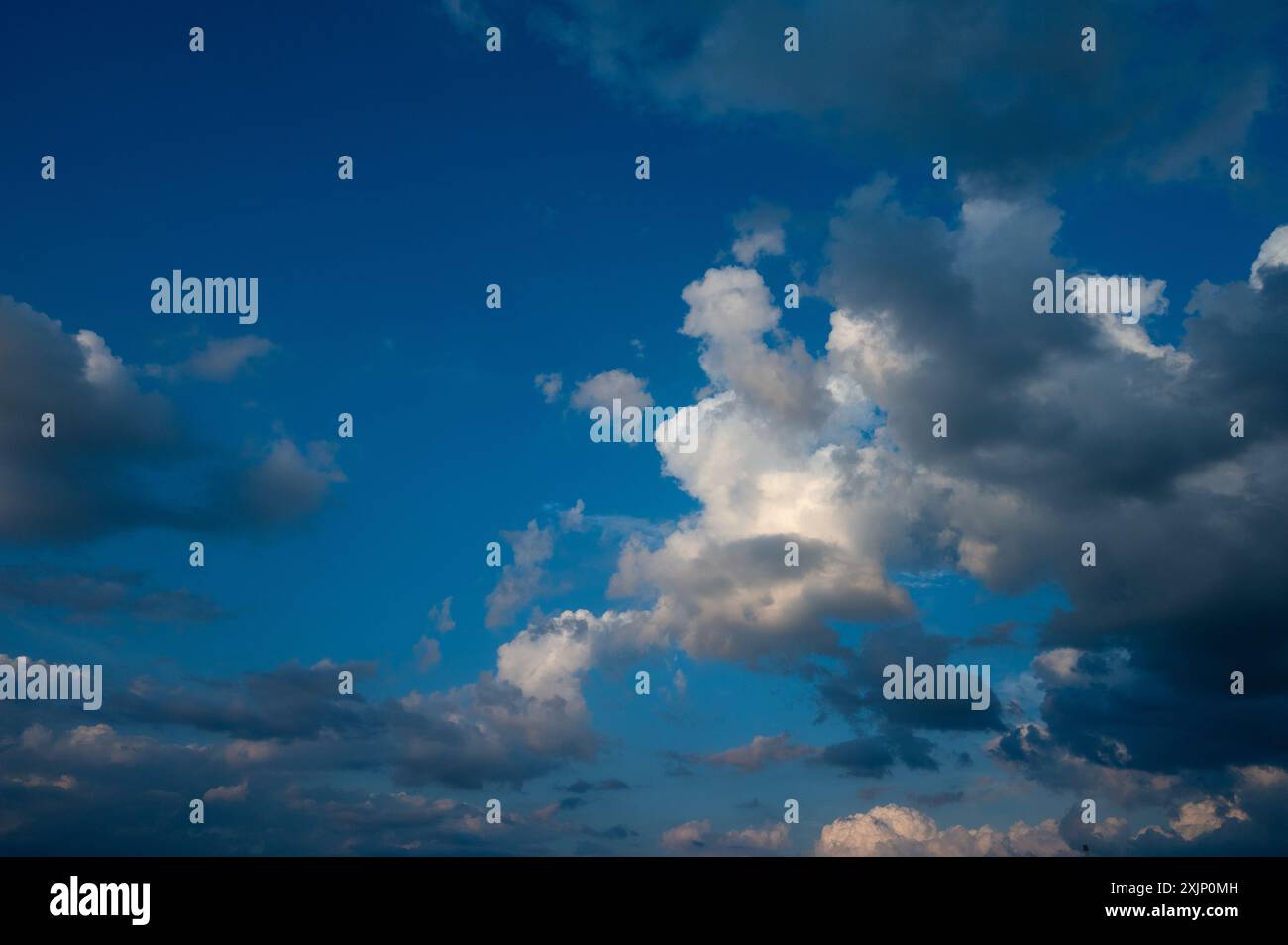 Evening sky in summer with cumulus clouds and wispy clouds Stock Photo