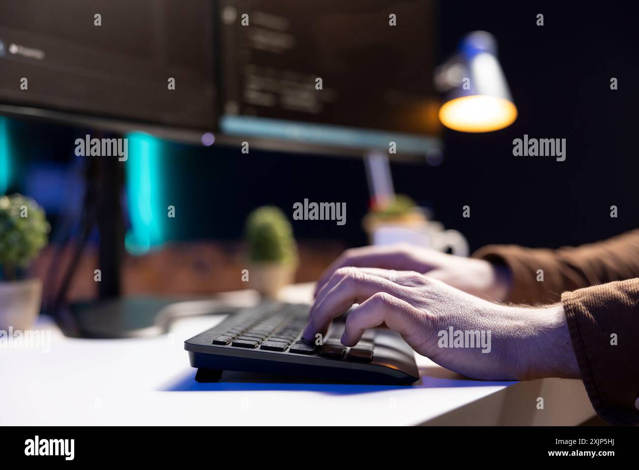 Programmer typing on keyboard, implementing and maintaining security measures to protect company systems and data. Expert writing, testing and debugging Java code for software applications, close up Stock Photo