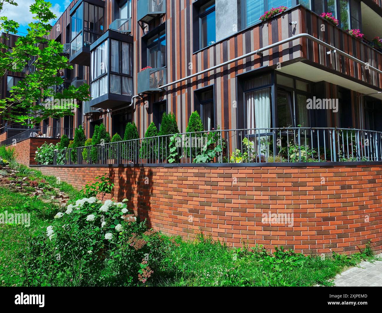 Photo inspiration: Green Apartment Graphics Reference: A Modern Apartment Building Featuring A Brick Wall And Beautiful