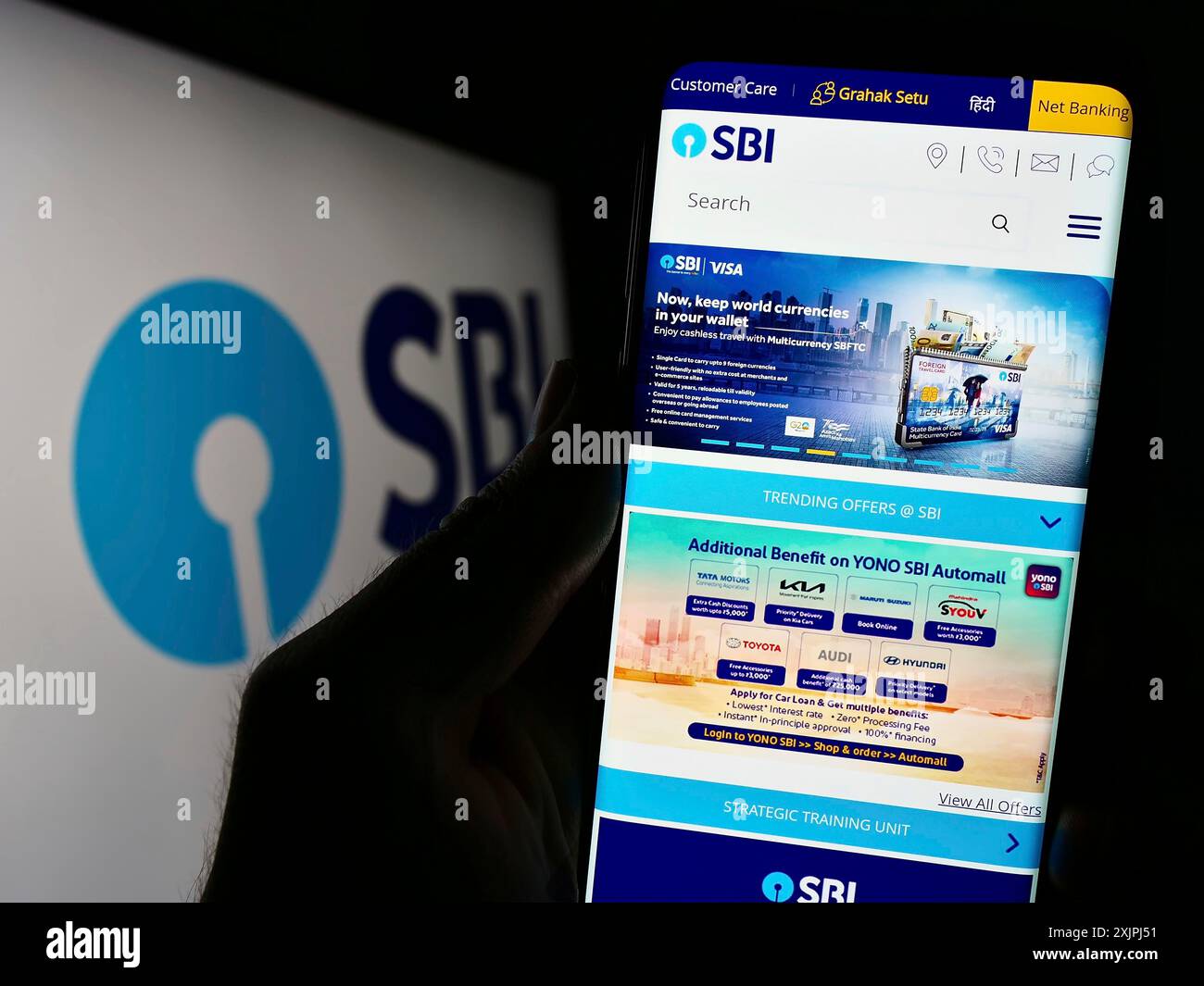 Stuttgart, Germany, 06-30-2023: Person holding cellphone with website of Indian company State Bank of India (SBI) on screen in front of logo. Focus Stock Photo