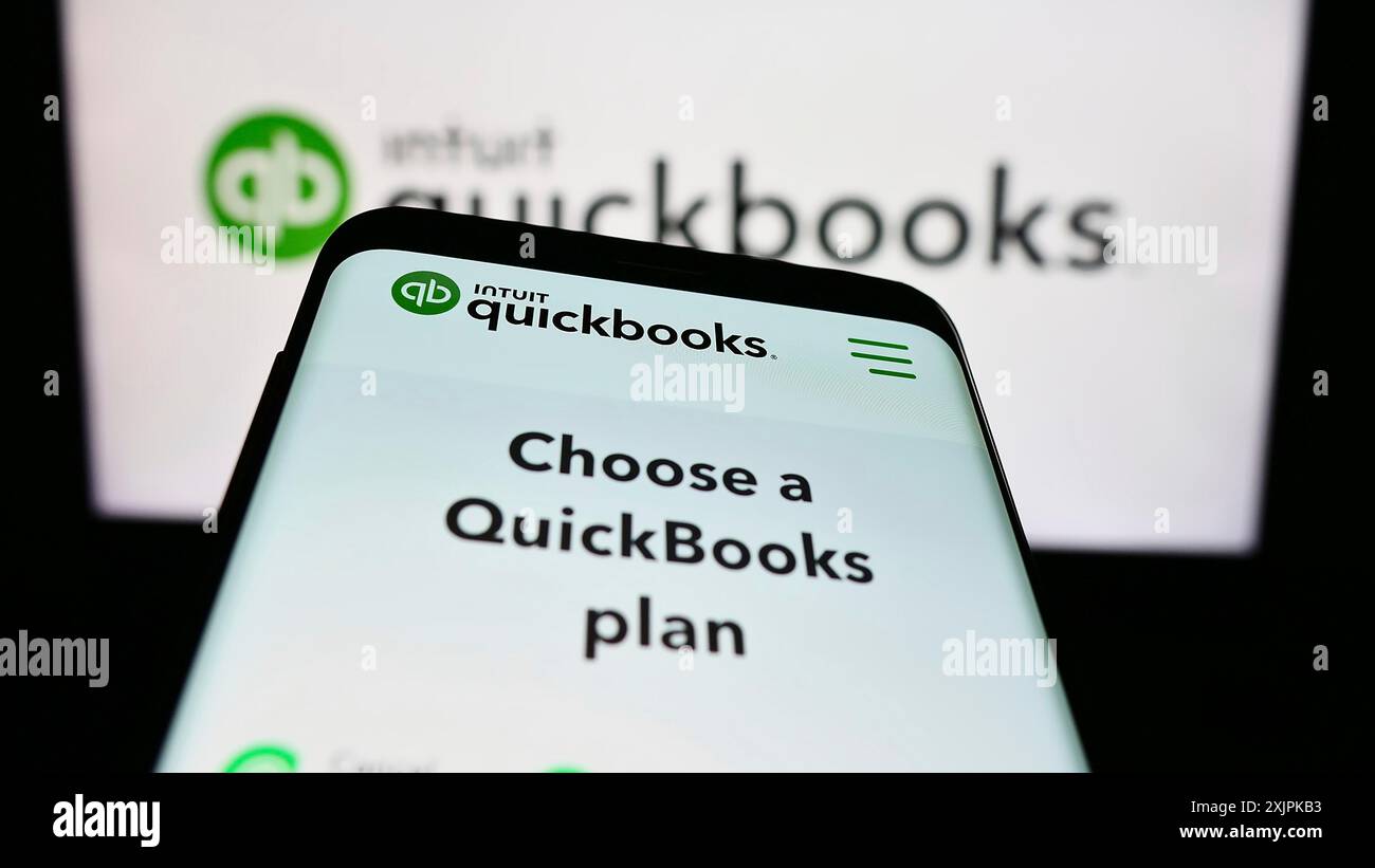 Stuttgart, Germany, 07-09-2023: Smartphone with website of accounting software QuickBooks on screen in front of business logo. Focus on top-left of Stock Photo
