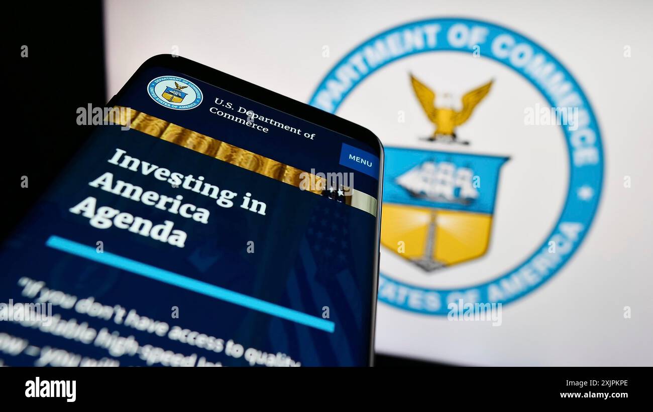 Stuttgart, Germany, 07-15-2023: Mobile phone with website of the United States Department of Commerce (DOC) on screen in front of seal. Focus on Stock Photo