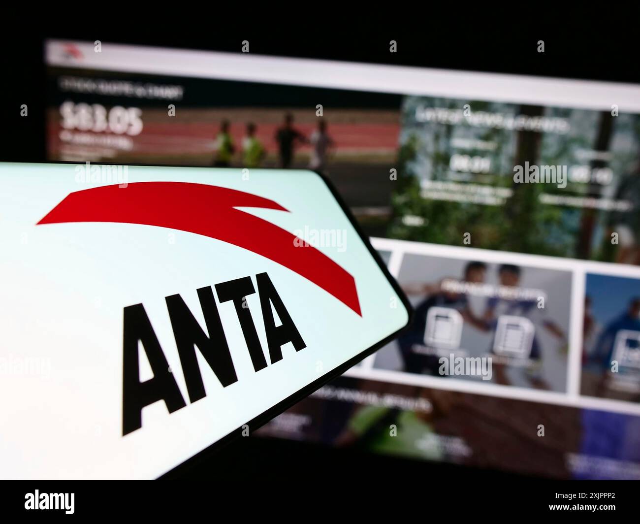 Stuttgart, Germany, 08-15-2023: Mobile phone with logo of Chinese company Anta Sports Products Limited on screen in front of website. Focus on Stock Photo