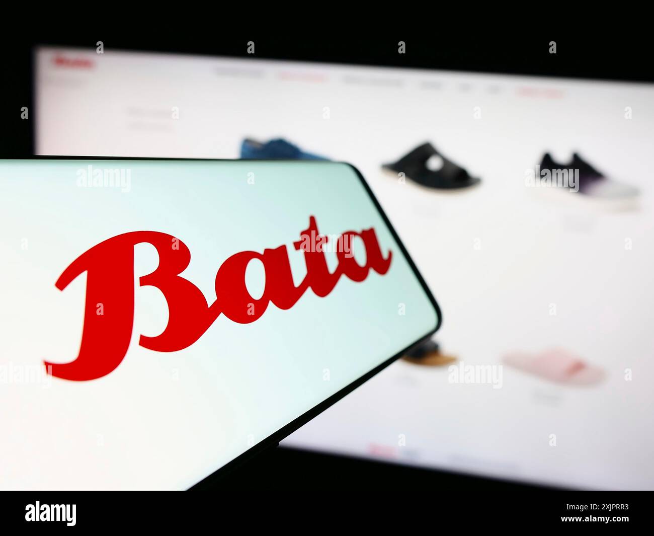 Stuttgart, Germany, 08-29-2023: Smartphone with logo of footwear company Bata Corporation on screen in front of business website. Focus on Stock Photo