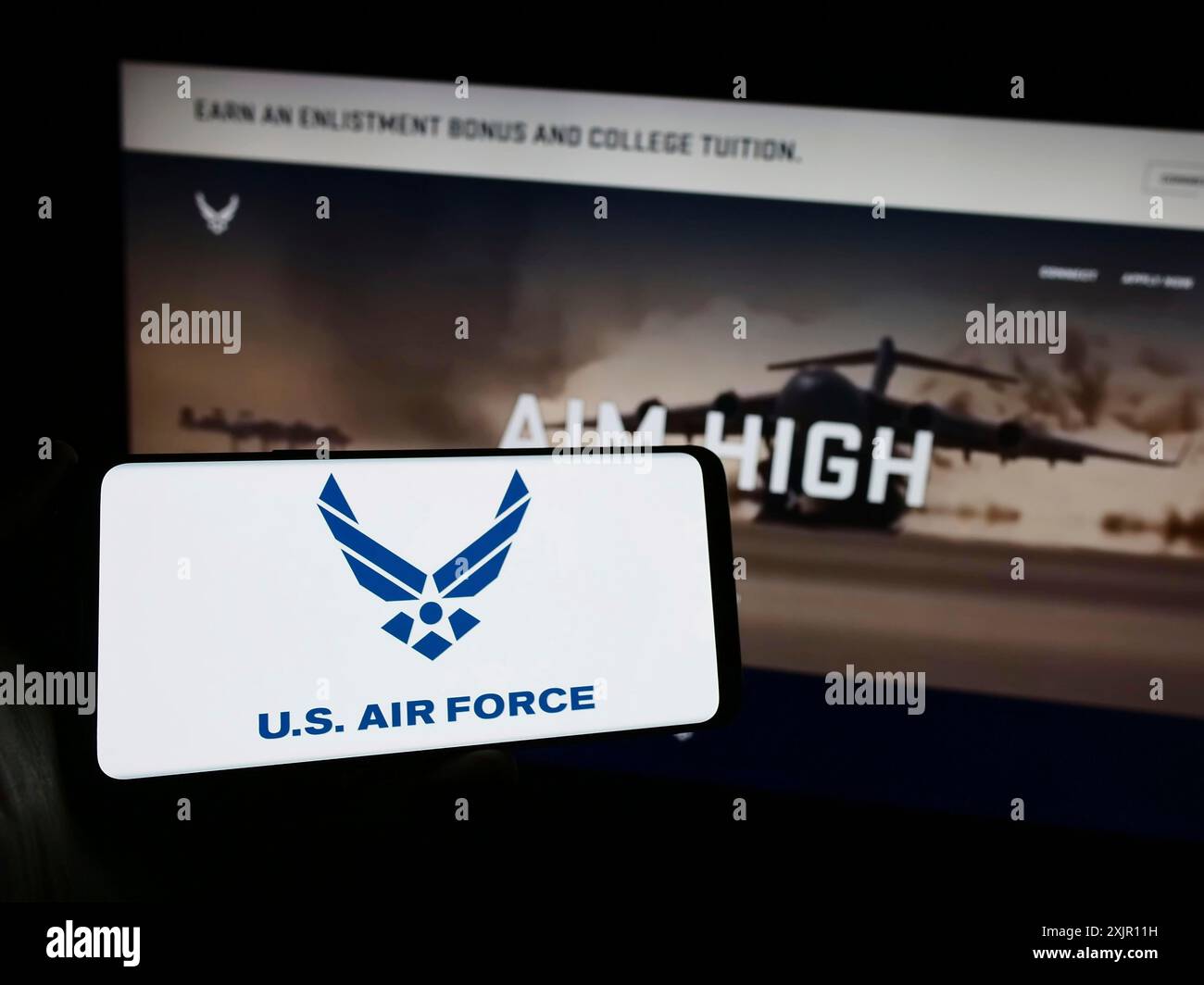 Stuttgart, Germany, 11-12-2023: Person holding mobile phone with logo ...