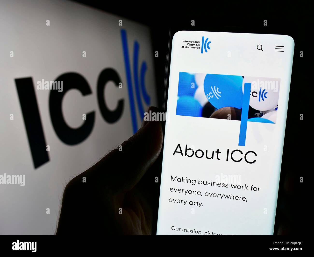 Stuttgart, Germany, 12-08-2023: Person holding cellphone with webpage of organisation International Chamber of Commerce (ICC) in front of logo. Focus Stock Photo