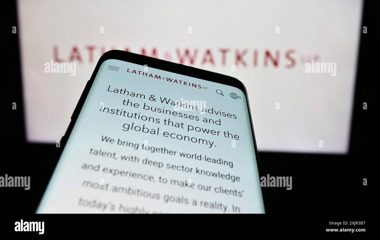 Stuttgart, Germany, 12-17-2023: Mobile phone with website of US law firm Latham and Watkins LLP (LW) in front of business logo. Focus on top-left of Stock Photo