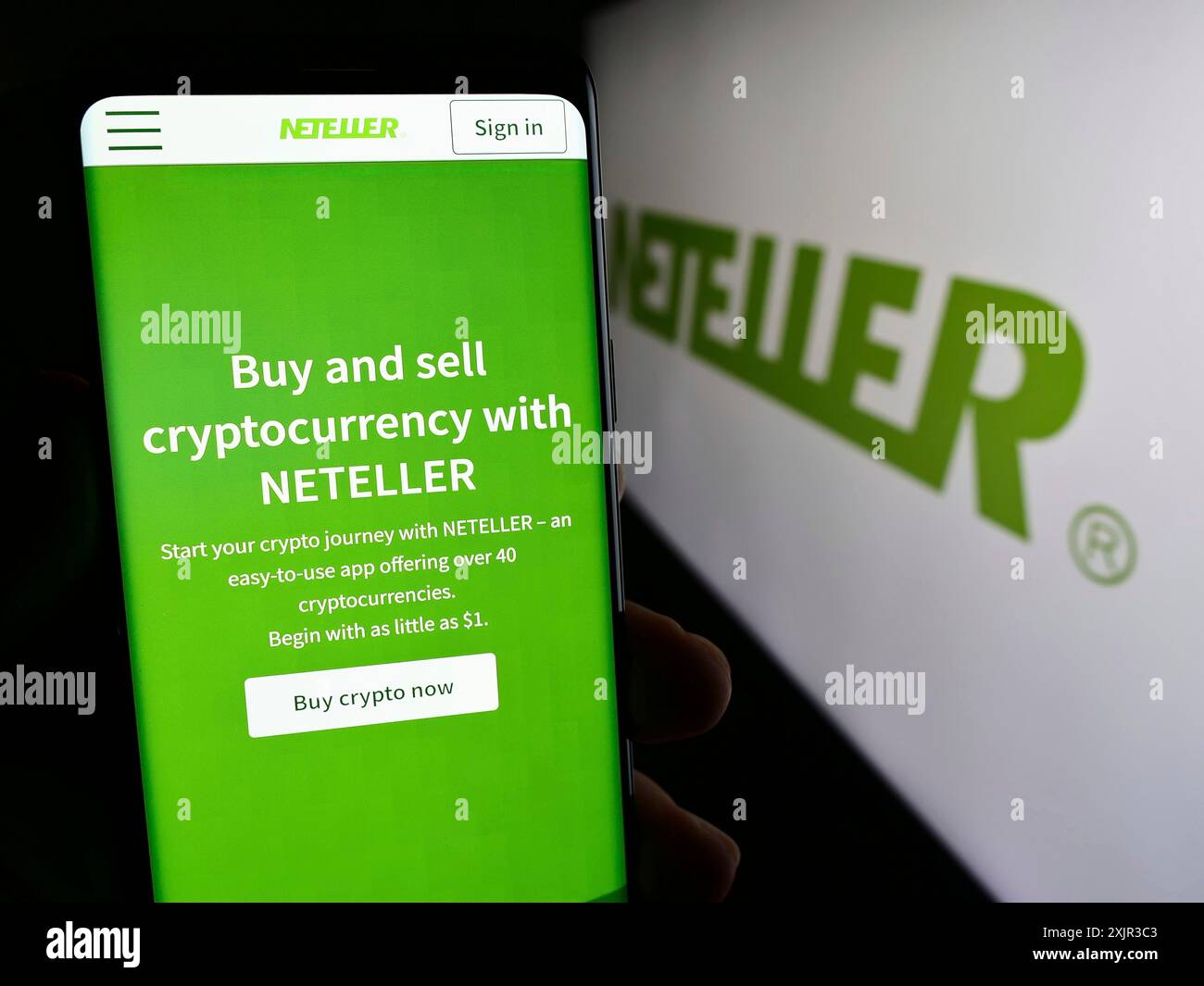 Cellphone with logo of global payments platform company Neteller in front  of business website. Focus on center-left of phone display Stock Photo -  Alamy