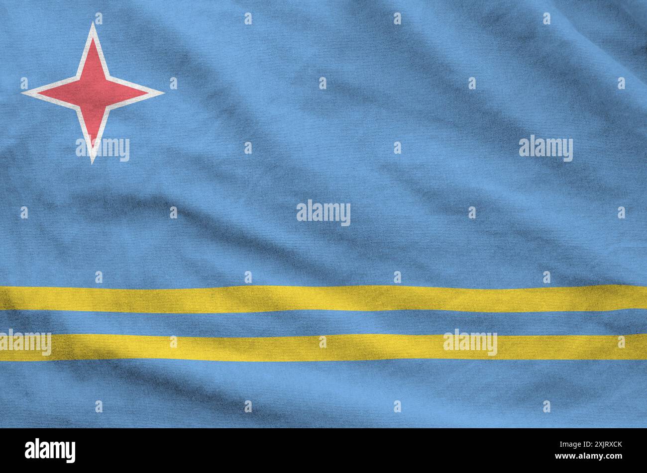 Aruba flag depicted on folded wavy fabric of old cloth close up Stock Photo