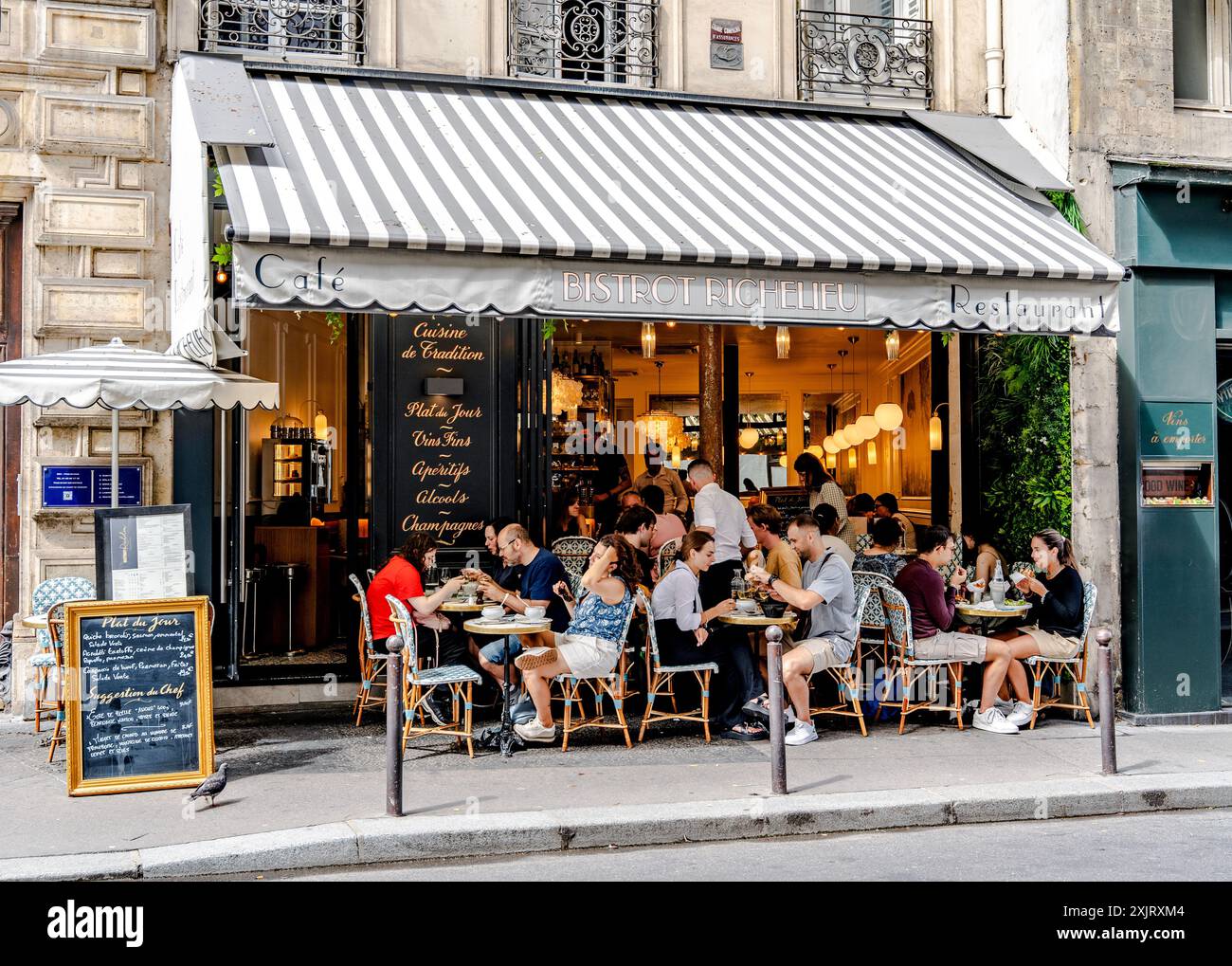 Bistro with clients in rue de Richelieu, a street in the Palais-Royal quarter, popular for its bistro and cafe, Paris, France Stock Photo