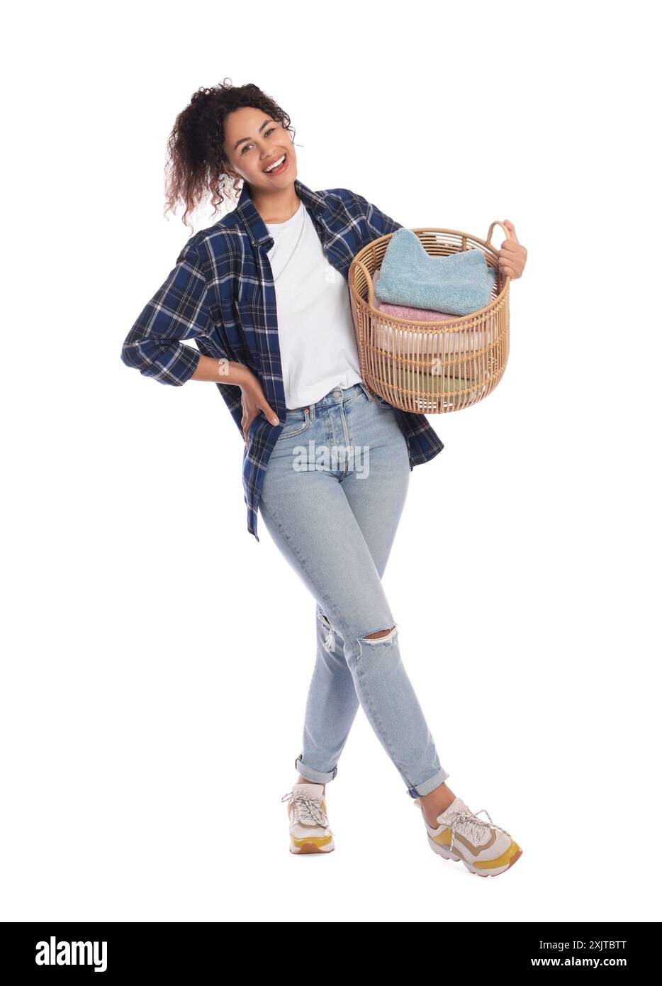 Happy woman with basket full of laundry on white background Stock Photo ...