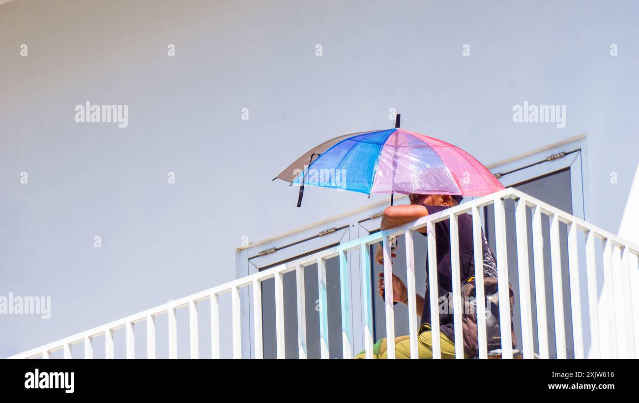People on the balcony a with white building Stock Photo - Alamy
