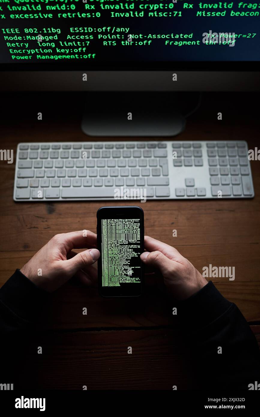 Phone, programmer hands and data screen with software for hacking crime or cyber security, download or virus. Hacker, programming and thief with Stock Photo