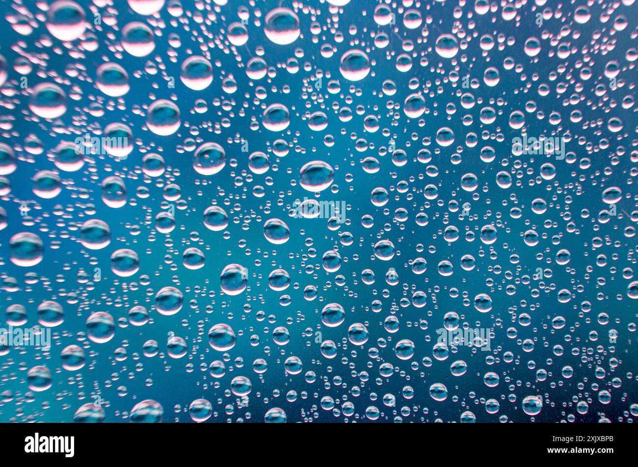 Clear water droplets with blue ocean cover background. Image suitable for wallpaper or any design background. Stock Photo