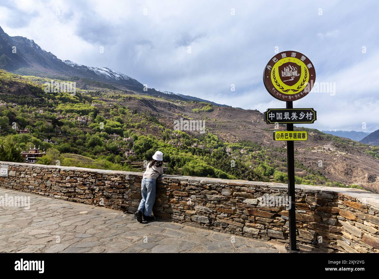 Tourist at viewing platform overseeing Danba Jiaju Tibetan Village with ...