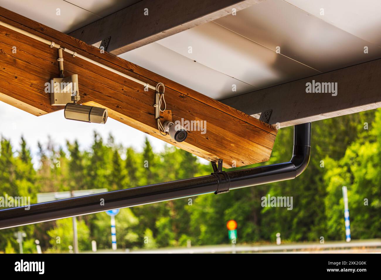 Close-up view of exterior security cameras mounted under roof of ...