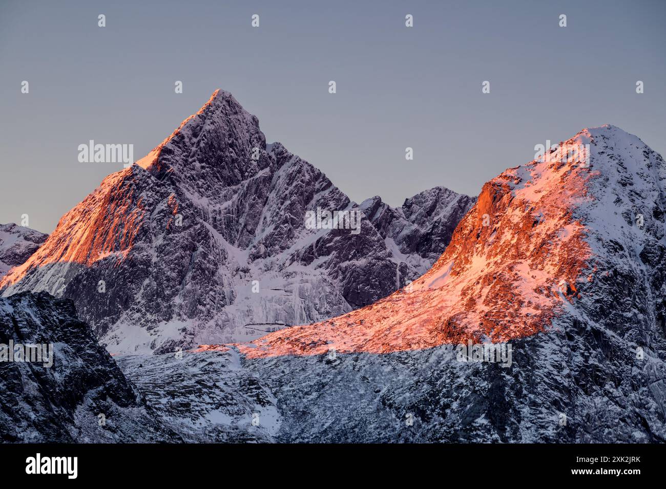 Majestic mountain peaks in Lofoten, Norway, bathed in the warm glow of ...