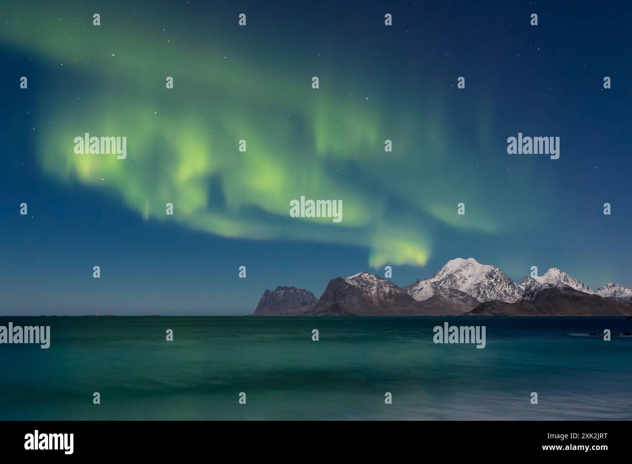 A stunning display of the Aurora Borealis lights up the sky over snow ...