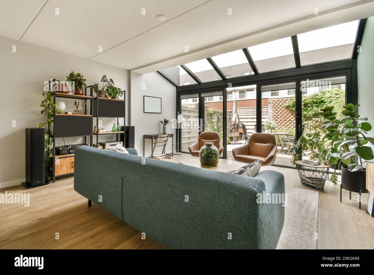 A cozy modern living room bathed in natural light features a ...