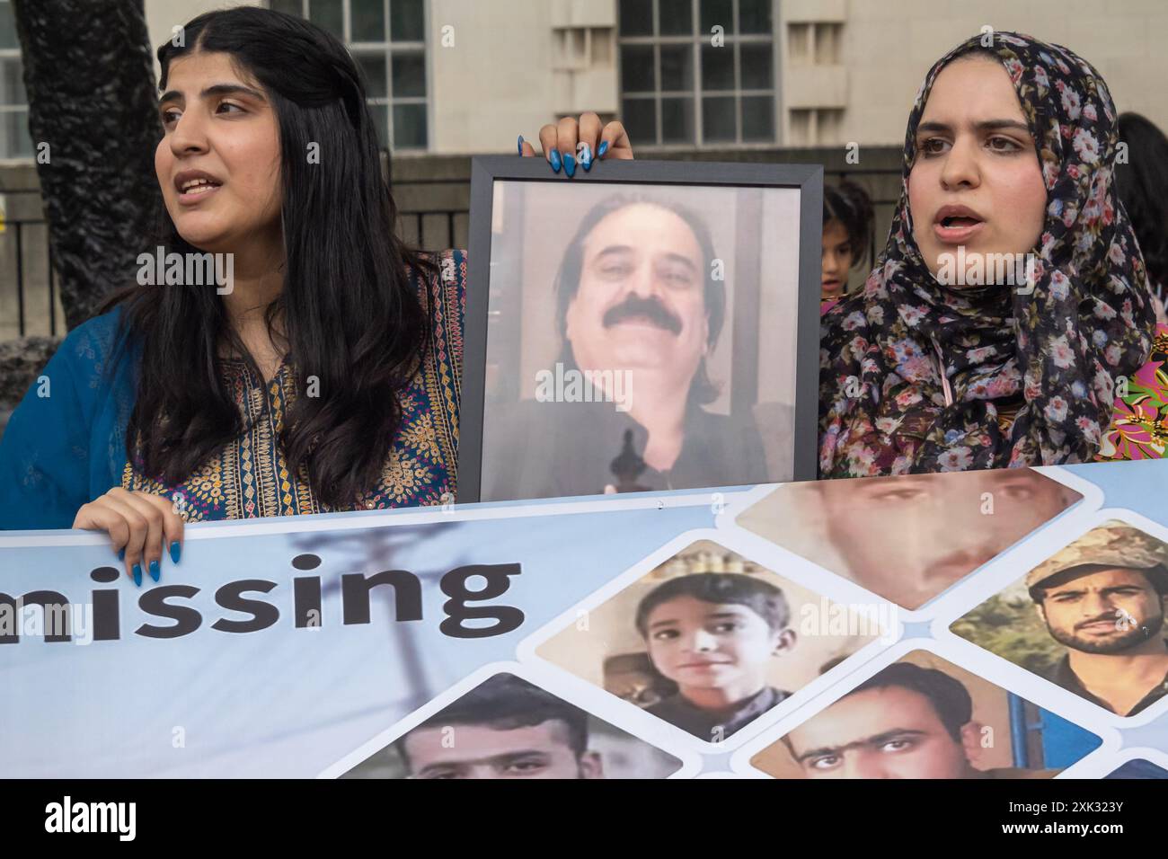 London, UK. 20 July 2024. Women hold a picture of Mir Taj Muhammad ...