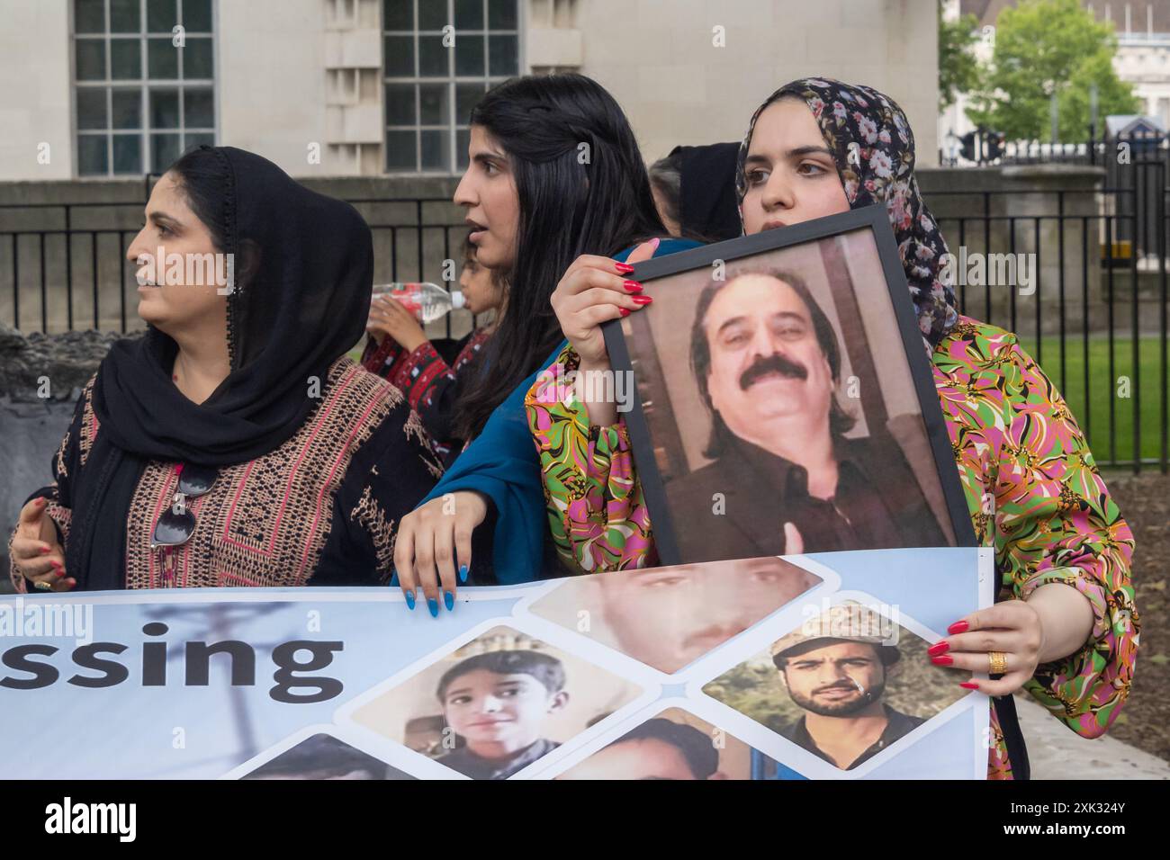 London, UK. 20 July 2024. Women hold a picture of Mir Taj Muhammad ...