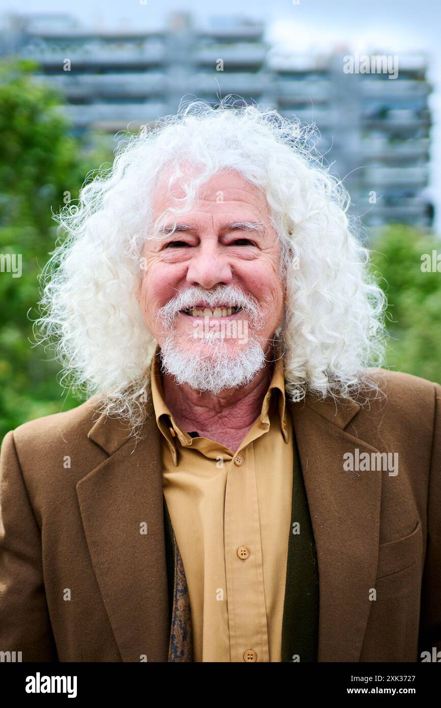 Portrait mature joyful long gray hair and beard male grandfather posing looking smiling at camera. Stock Photo