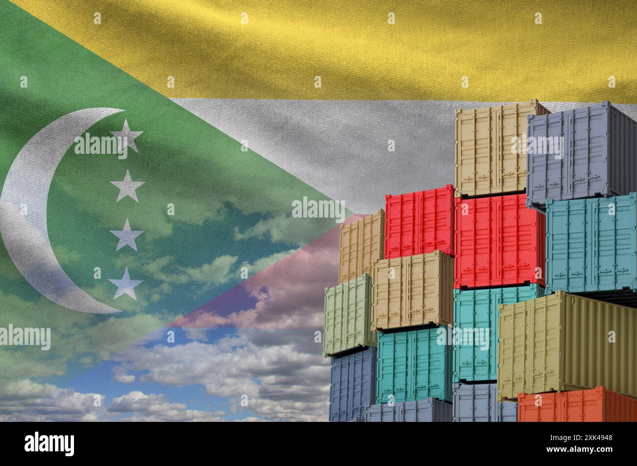 Comoros flag and big stack of shipping cargo containers in docks with sky background close up Stock Photo