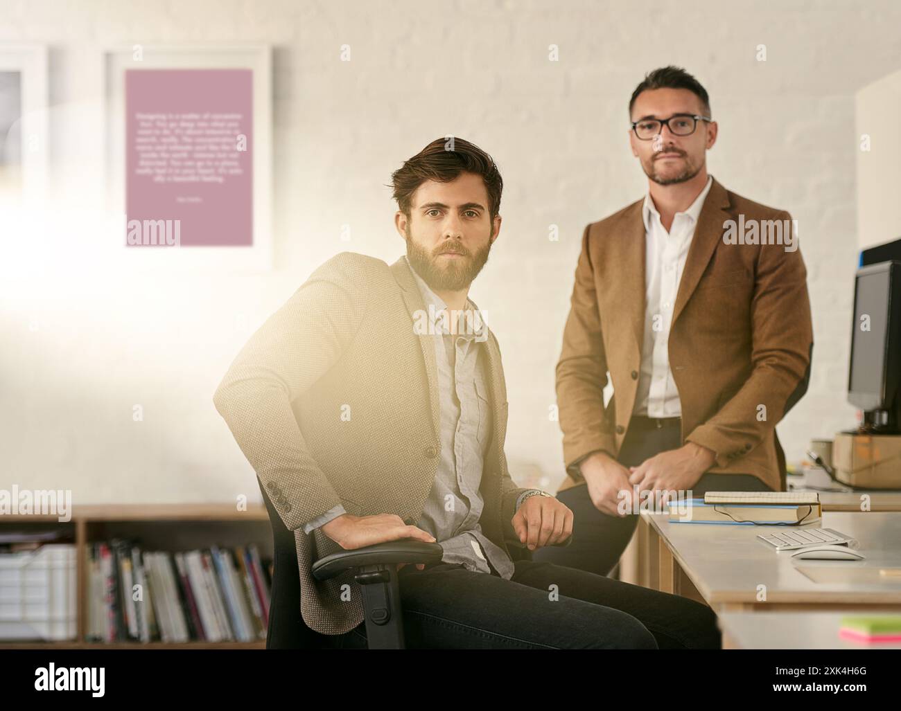 Small business, businessmen and portrait in office for design, creativity and working at computer. Web designers, desk and face in workplace for Stock Photo