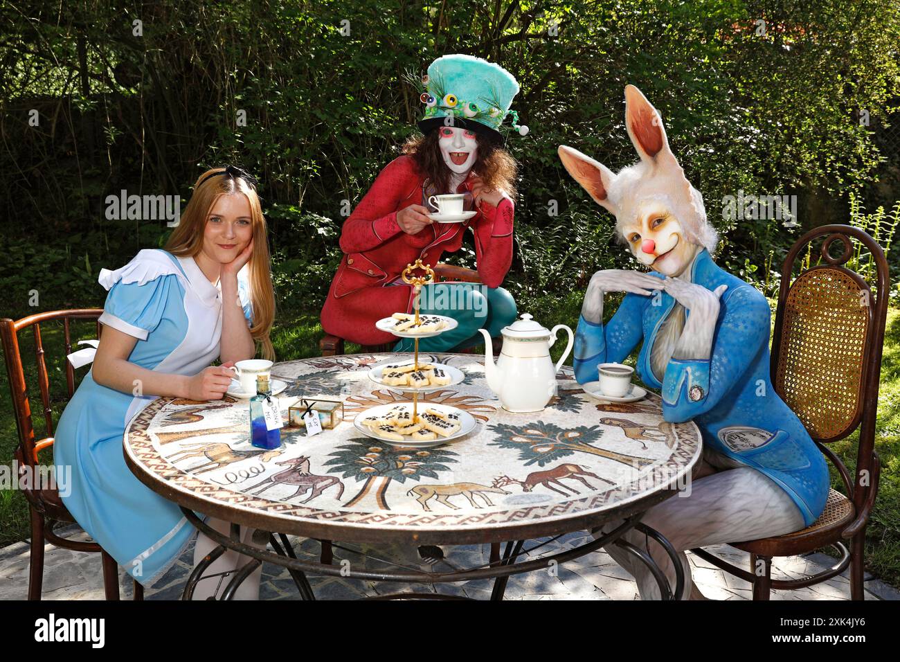 GEEK ART - Bodypainting and Transformaking: Alice in Wonderland photoshooting with Melina as Alice, Julia as the Mad Hatter and Janina as the White Rabbit in the Czarnecki Garden in Hameln. - A project by photographer Tschiponnique Skupin and bodypainter Enrico Lein Stock Photo
