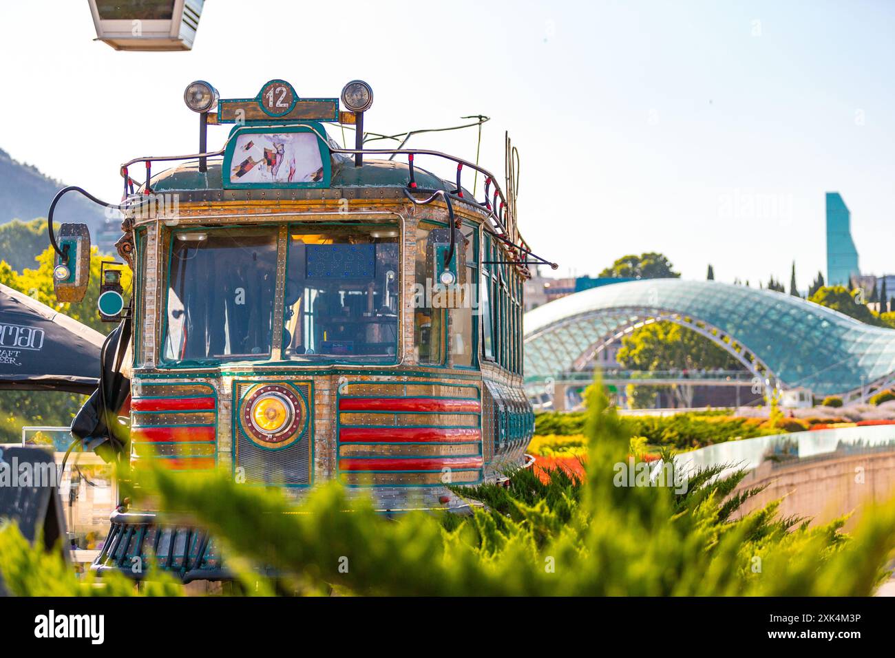 Tbilisi, Georgia - June 22, 2024: Old train car modified as a vintage style cafe at the Rike Park in Tbilisi, Georgia. Stock Photo