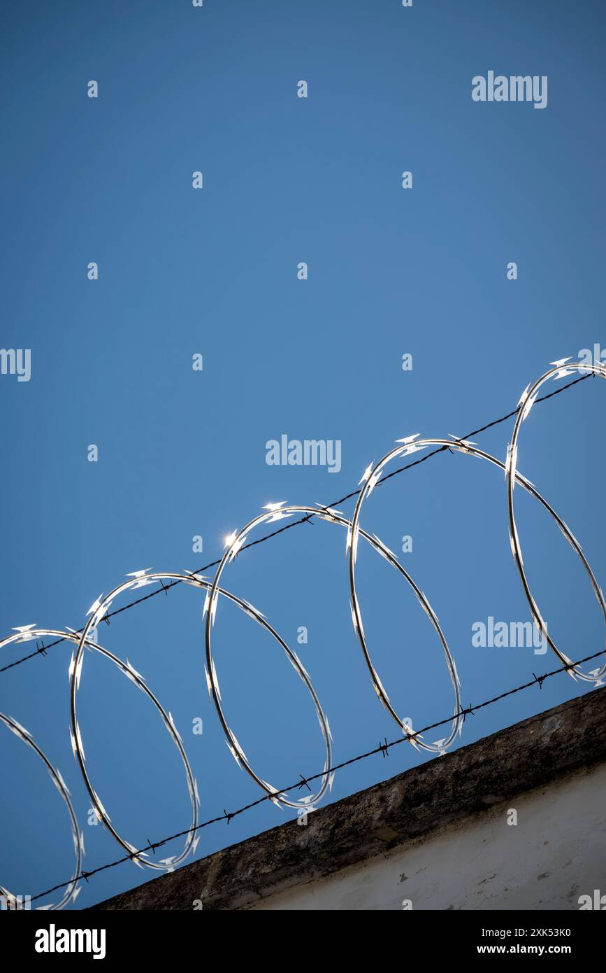 Fence and barbed wire on roof of a house,  Santa Ana, El Salvador, Central America Stock Photo