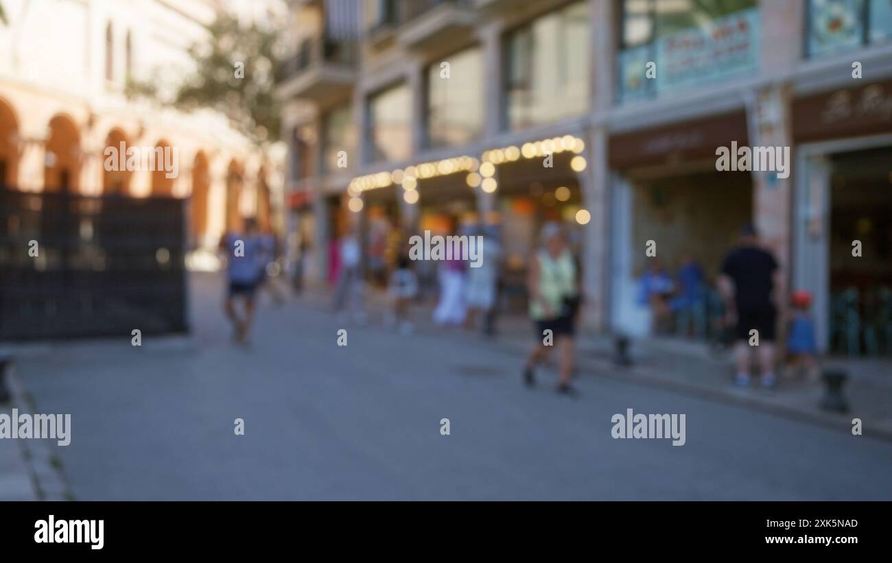 Blurred people walking outdoors in a defocused mallorca street with ...