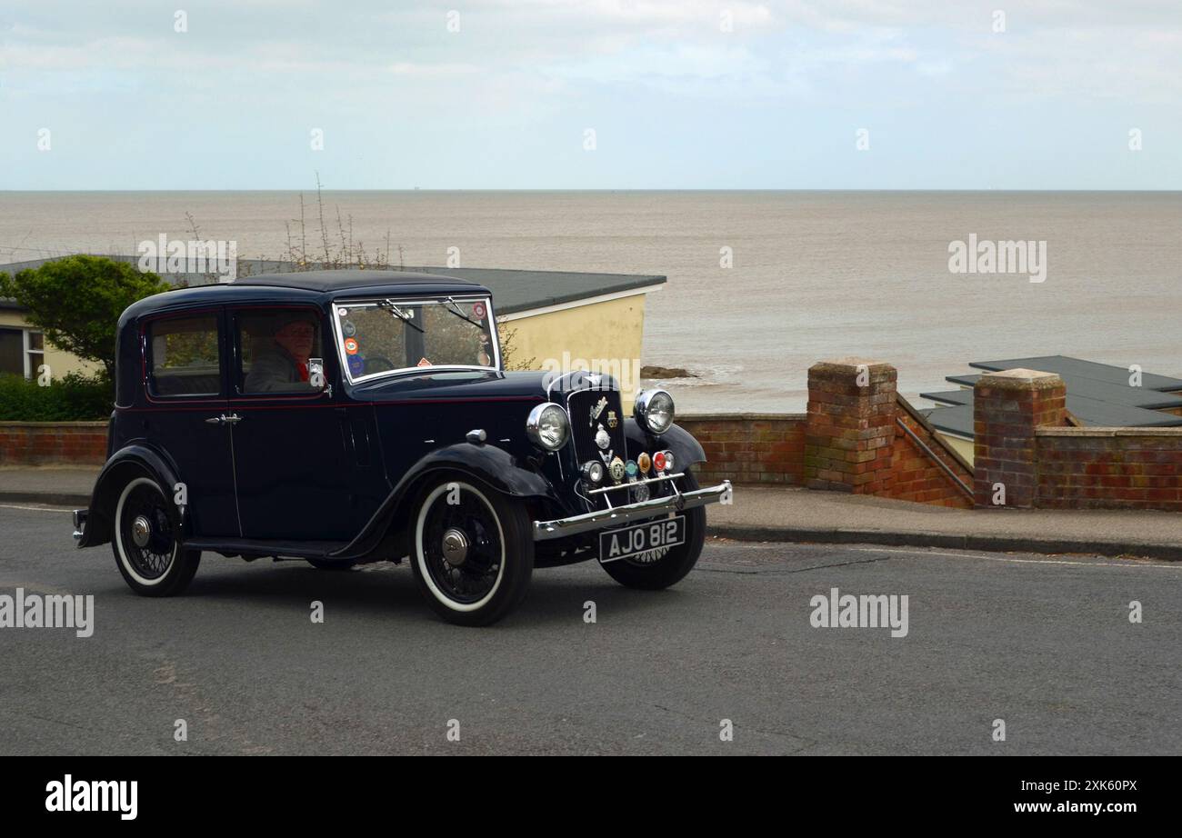 Vintage 1935 Austin 10 car being driven along seafront Stock Photo