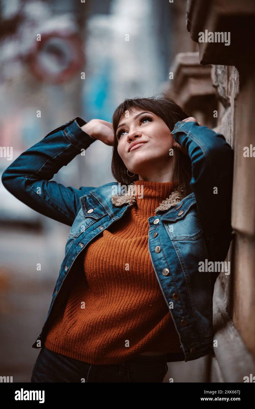 Woman in orange jacket leans hi-res stock photography and images - Alamy