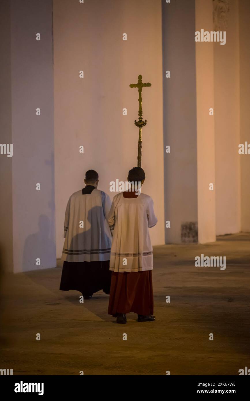Procession during the Lent led by a two priests, one carrying a cross, in front of Leon Cathedral, Leon, Nicaragua Stock Photo