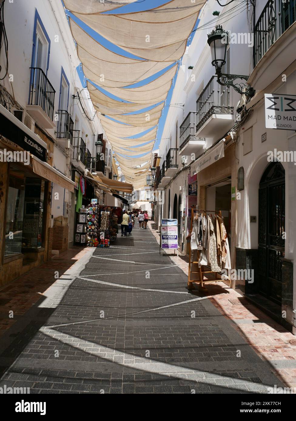 Shelter from the sun and heat offered by shade sails hung between buildings on Calle Pintada, Nerja, Andalusia, Spain Stock Photo