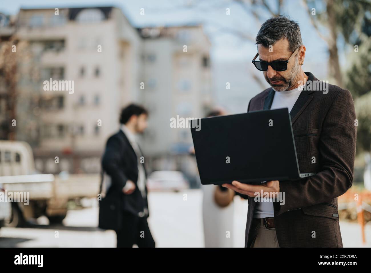 Stylish businessman in suit on sunny city street hi-res stock ...