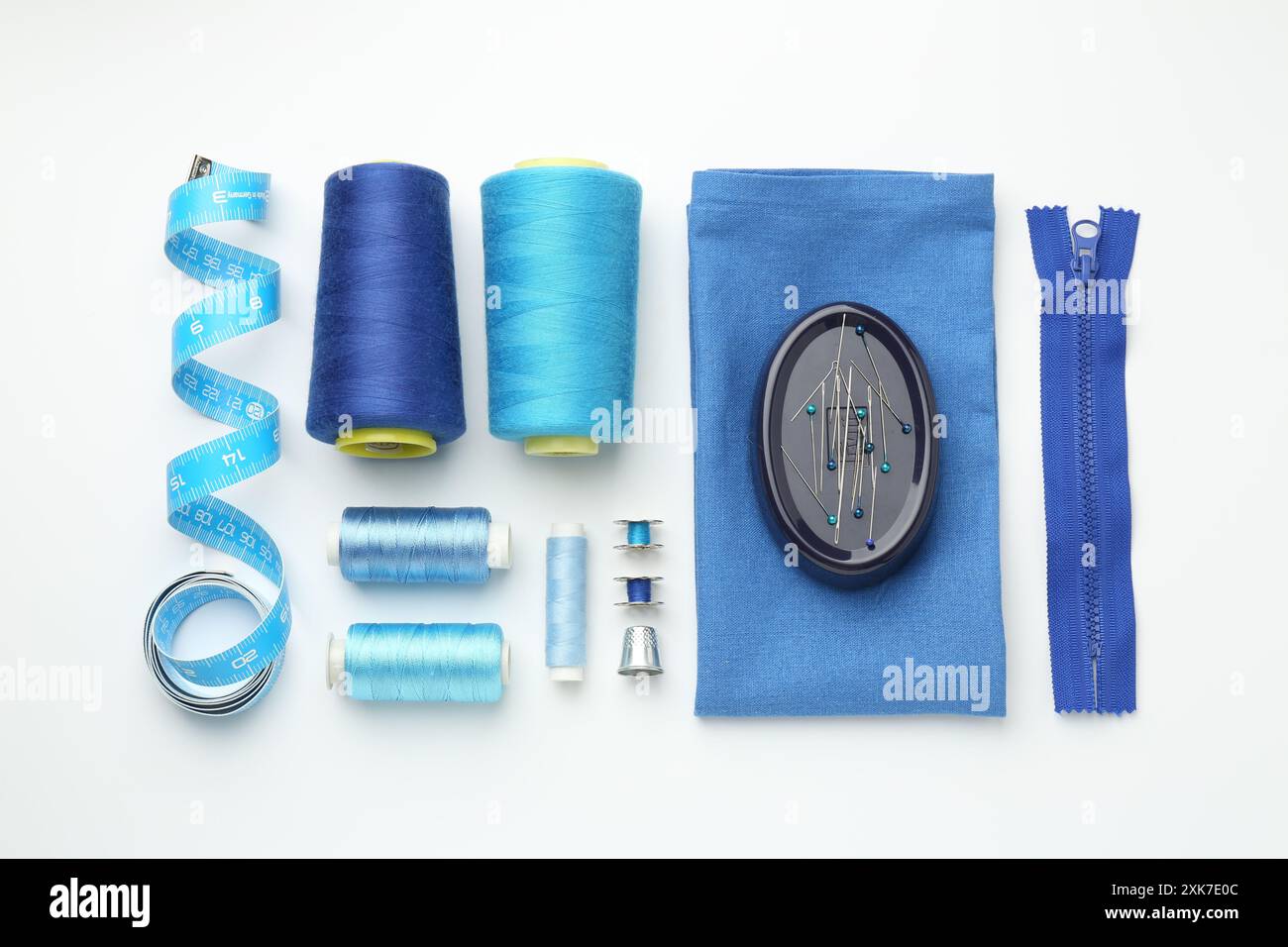 Flat lay composition with different sewing supplies on white background Stock Photo