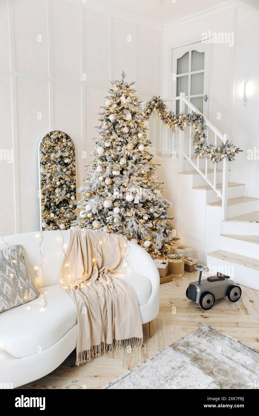 An elegant white leather sofa against the backdrop of a large Christmas ...