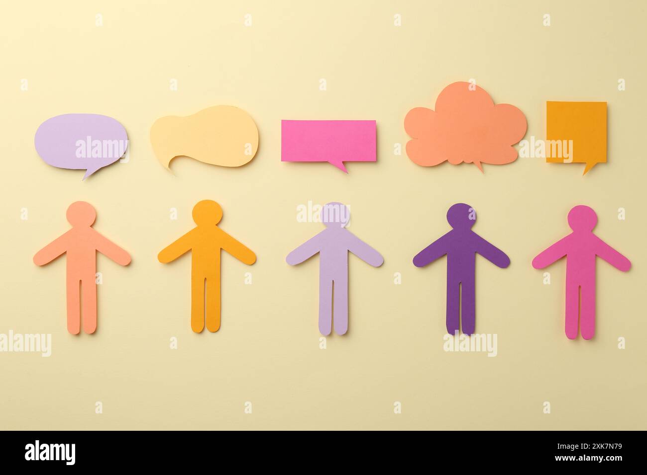 Equality concept. Paper human figures and different speech bubbles on beige background, flat lay Stock Photo