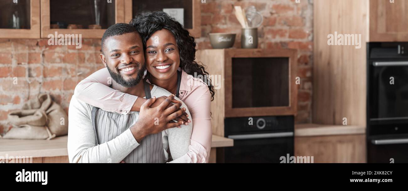 Grateful african woman hugging her husband at kitchen Stock Photo - Alamy