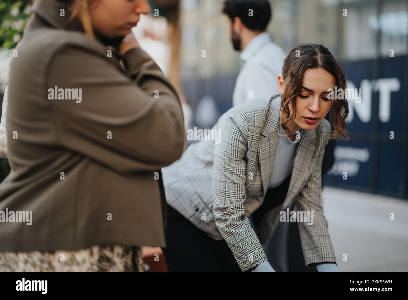 Focused team collaborating on a project outdoors Stock Photo