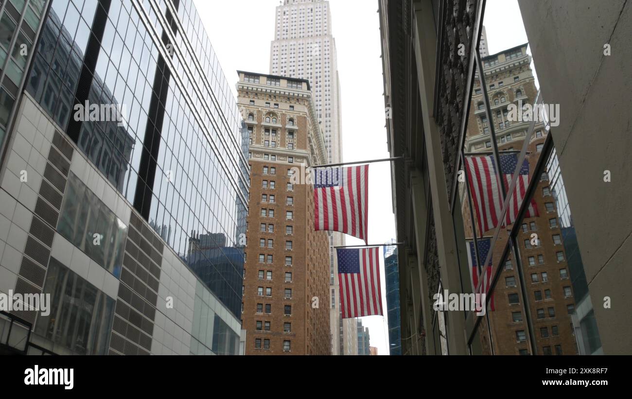 New York, american flag waving. Empire State Building. Manhattan ...