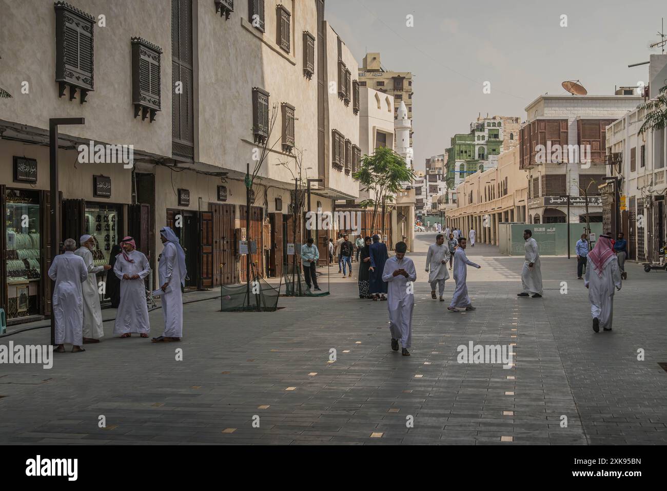 The local Saudi people on the streets of Jeddah downtown, a big city in the west of Saudi Arabia, with modern and old Arabic architecture. Stock Photo