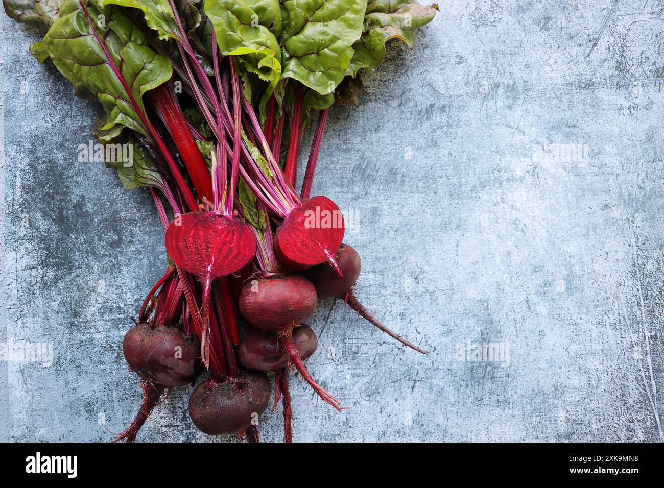Fresh beetroot with leaves on a blue background. Healthy food. Top view ...